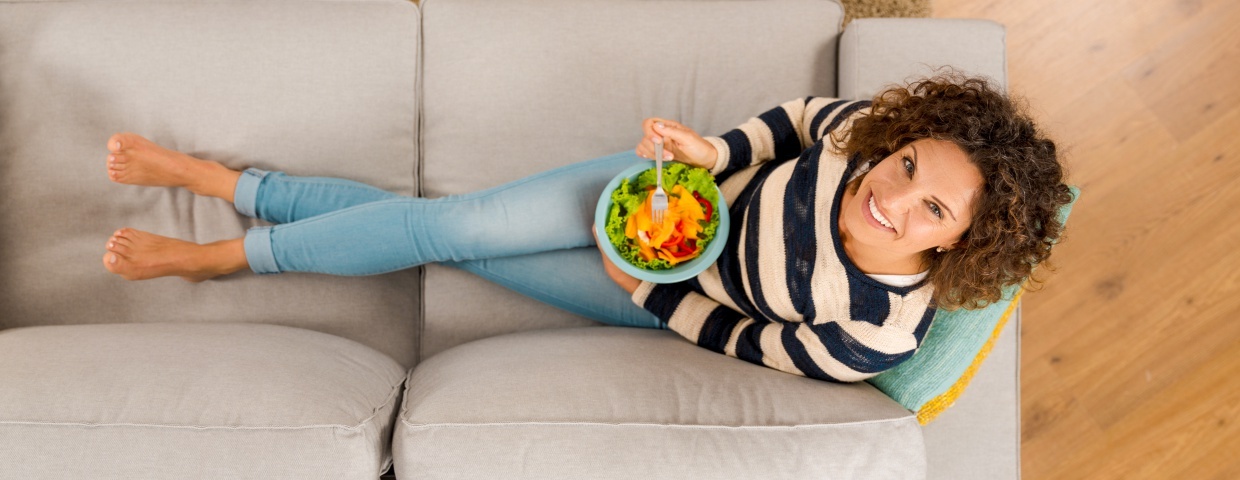 healthy woman eating a salad 