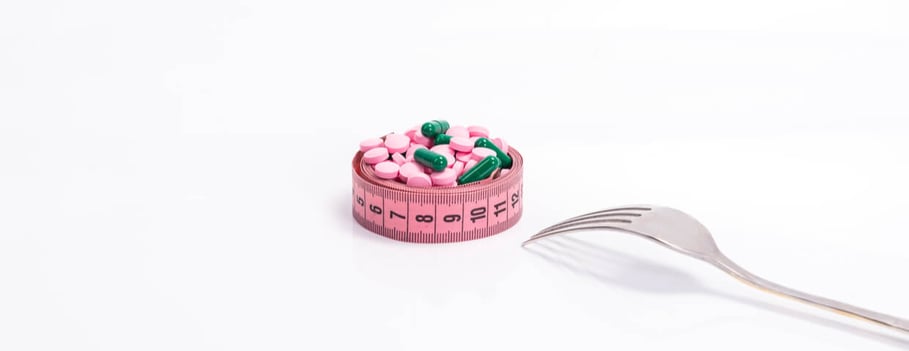 rx on a rolled pink measuring tape with fork