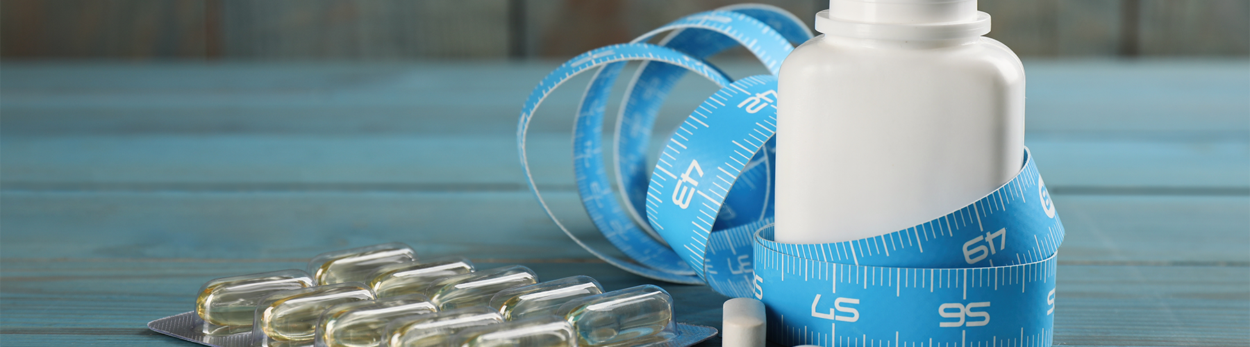 blue color scheme pills, measuring tape, and bottle