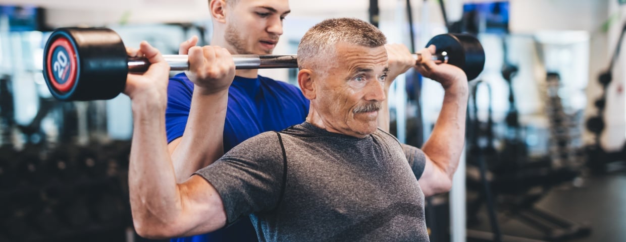 older man lifting weights