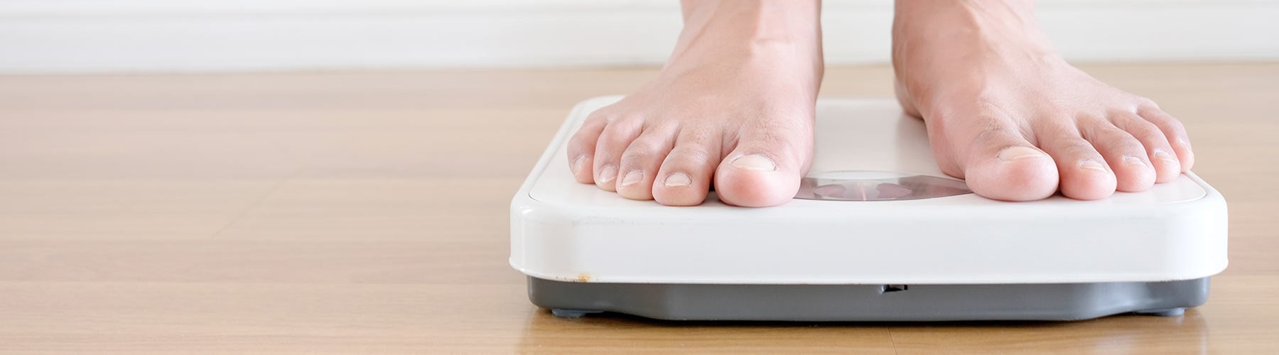 person standing on a scale after using medical weight loss treatment