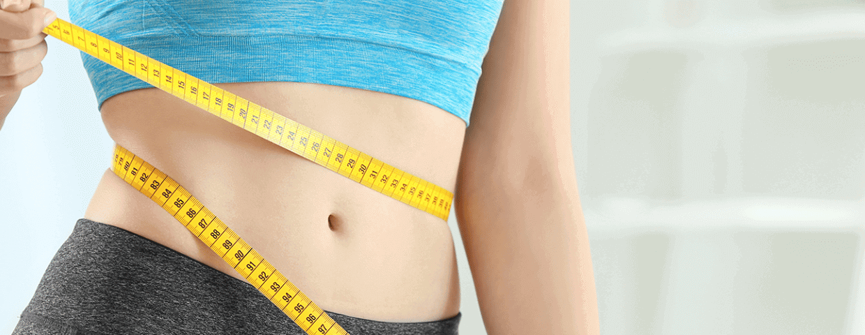 woman measuring waist with tape measure