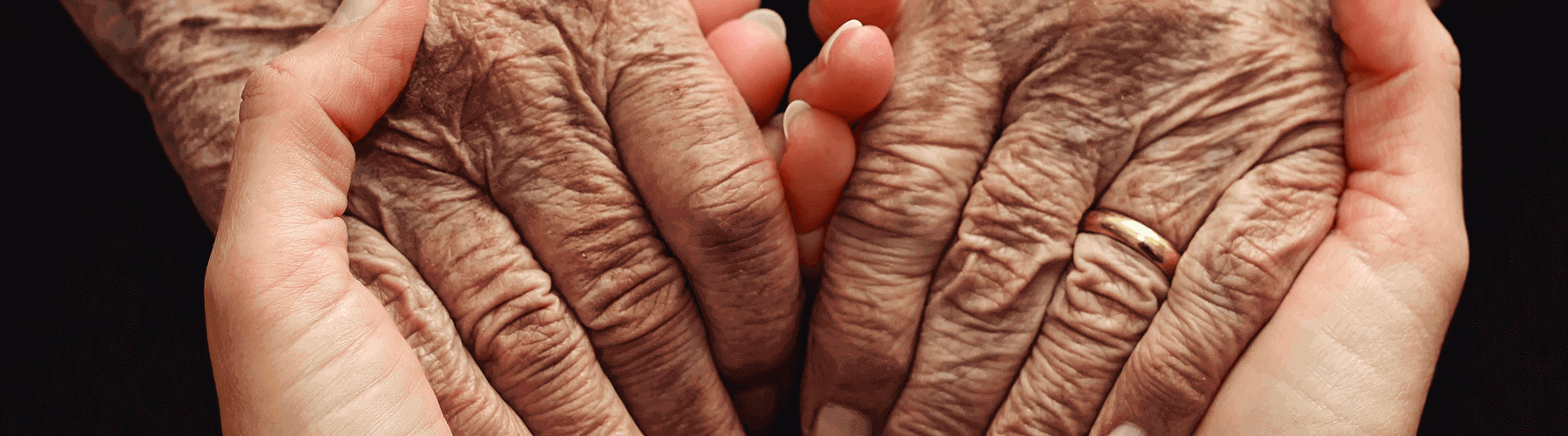 young person and old person holding hands