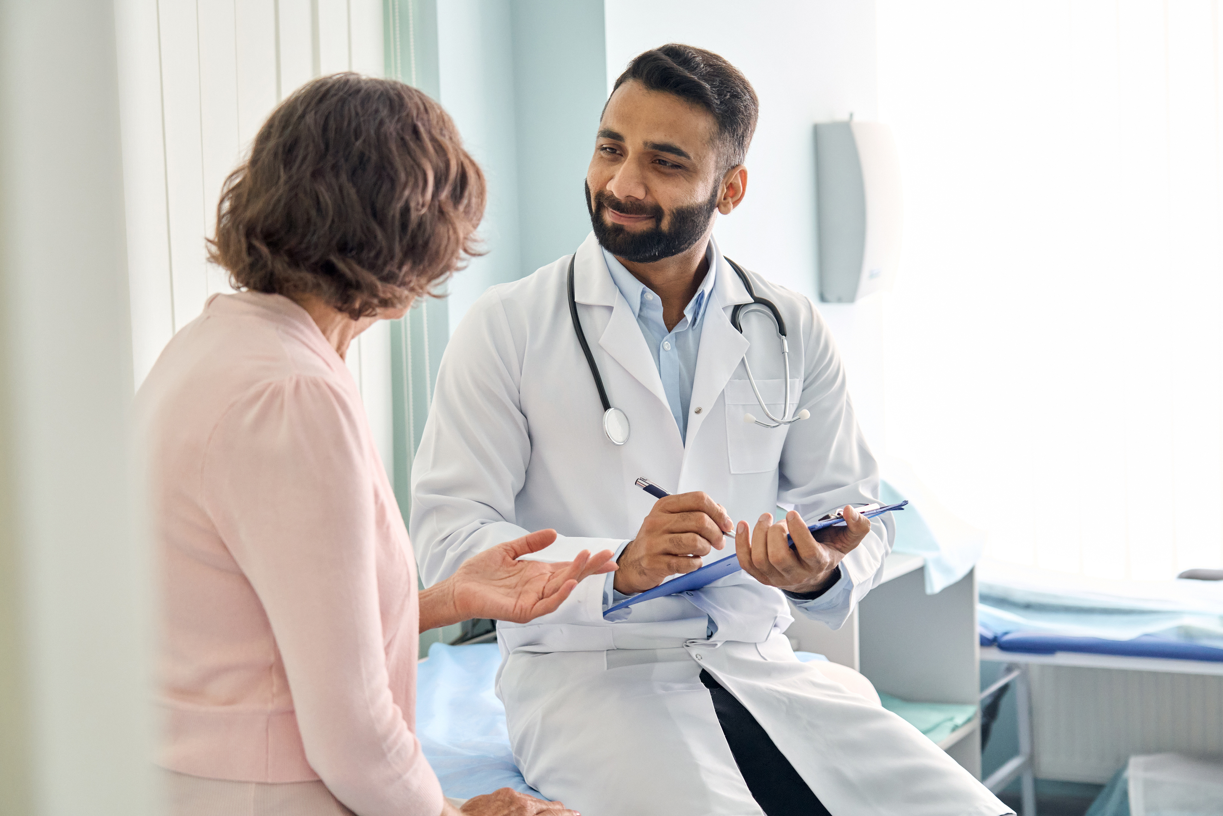 A medical professional consulting with a patient about the Impact of B12/MIC and Vitamin C on Weight Loss.