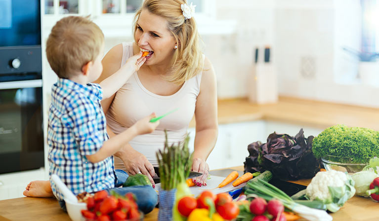 Mother and son cooking together in a kitchen