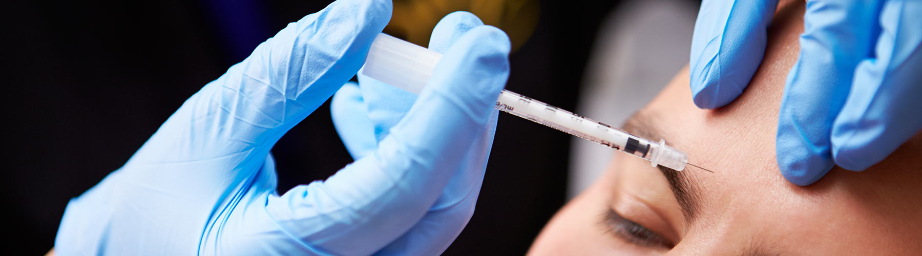 Man having a botox injection in his brow